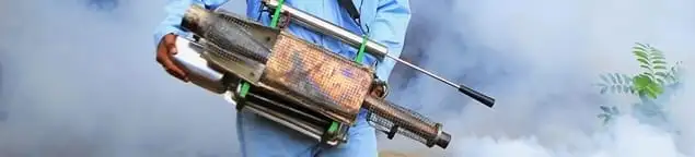 Fumigation technician using a fogger for deep pest treatment in Hialeah, FL